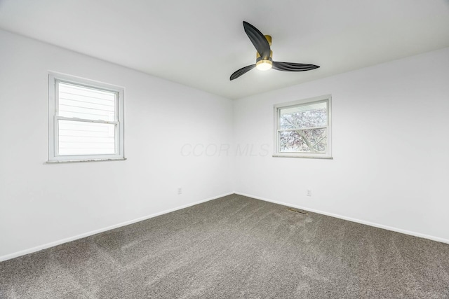 spare room featuring carpet and ceiling fan