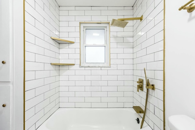 bathroom with tiled shower / bath combo and toilet