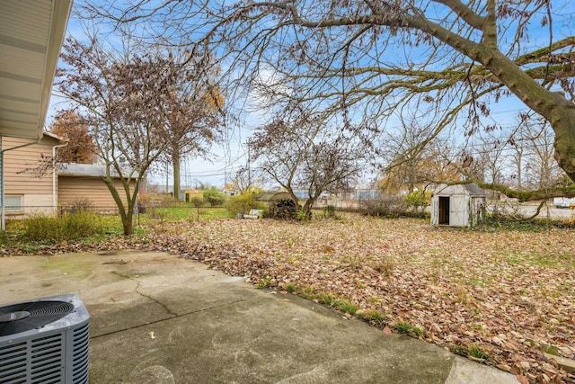 view of yard with cooling unit, a patio, and a shed