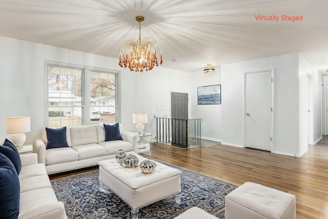 living room with hardwood / wood-style floors and a chandelier