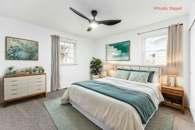 bedroom featuring light colored carpet and ceiling fan