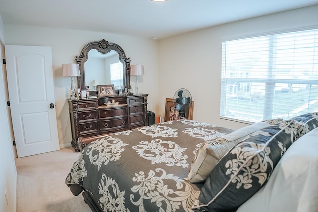 bedroom featuring multiple windows and light colored carpet