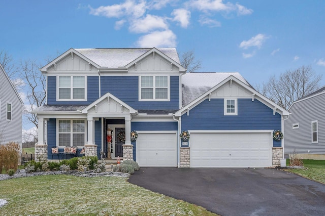 craftsman house featuring a garage and a front lawn