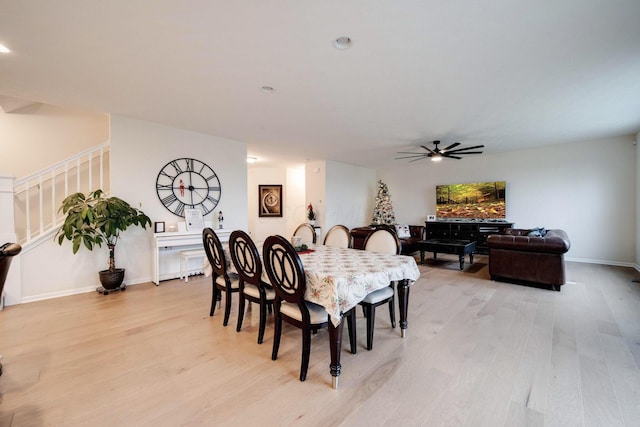 dining space featuring ceiling fan and light wood-type flooring