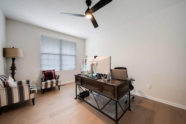 office space with ceiling fan and light wood-type flooring