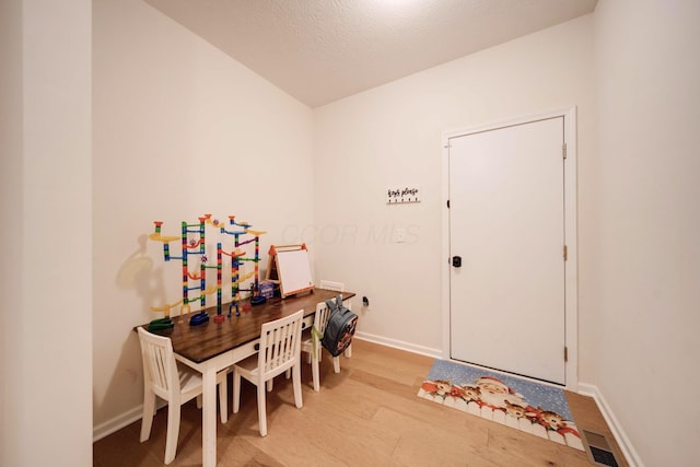 interior space with light hardwood / wood-style flooring and a textured ceiling