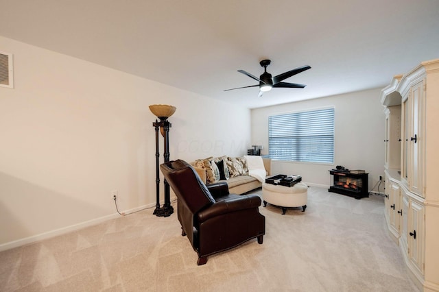 living room with ceiling fan and light colored carpet