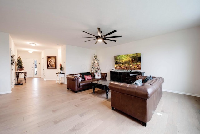 living room with light wood-type flooring and ceiling fan