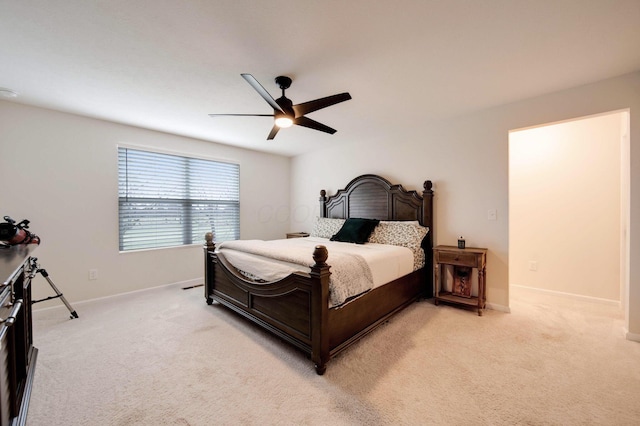 bedroom with ceiling fan and light carpet