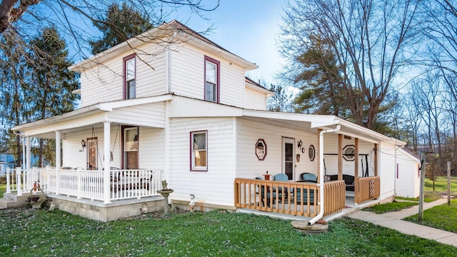 view of front of home featuring covered porch and a front lawn