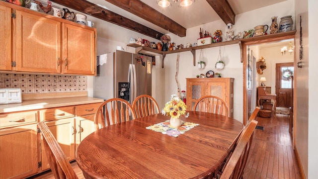 dining room featuring beam ceiling and dark wood-type flooring