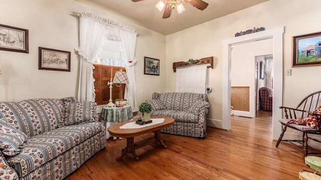 living room with hardwood / wood-style flooring and ceiling fan