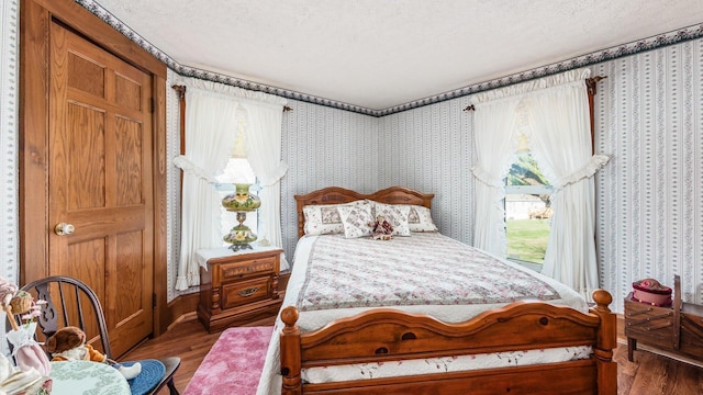 bedroom featuring hardwood / wood-style flooring and a textured ceiling