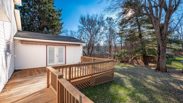 wooden deck with a yard and french doors