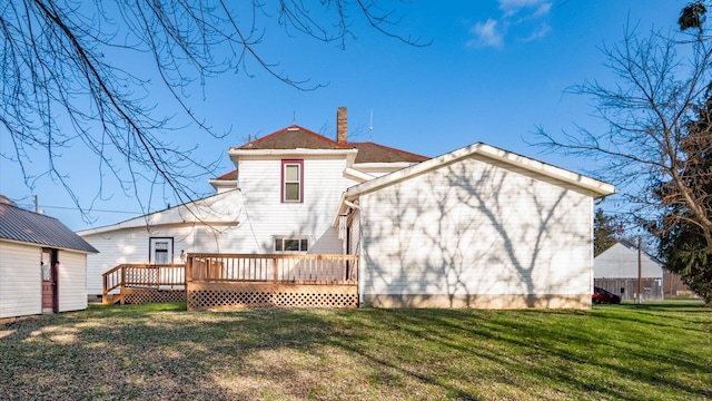 back of house featuring a yard and a deck