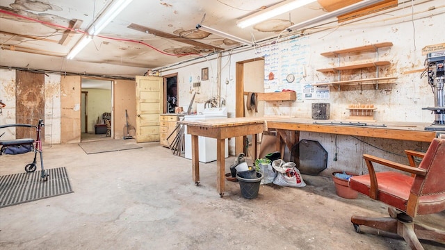 basement with a workshop area and washer / dryer