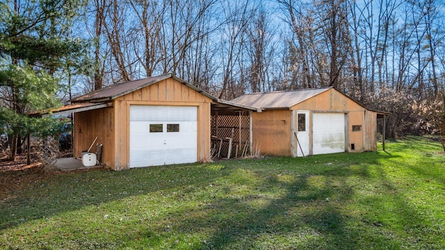 view of outbuilding with a garage and a yard