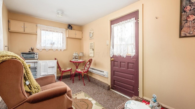 interior space featuring carpet floors and a baseboard heating unit