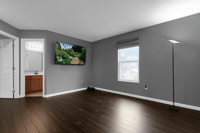 spare room with sink and dark hardwood / wood-style floors