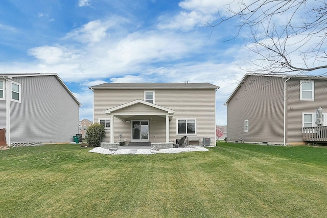 back of property featuring central AC unit, a patio area, and a lawn