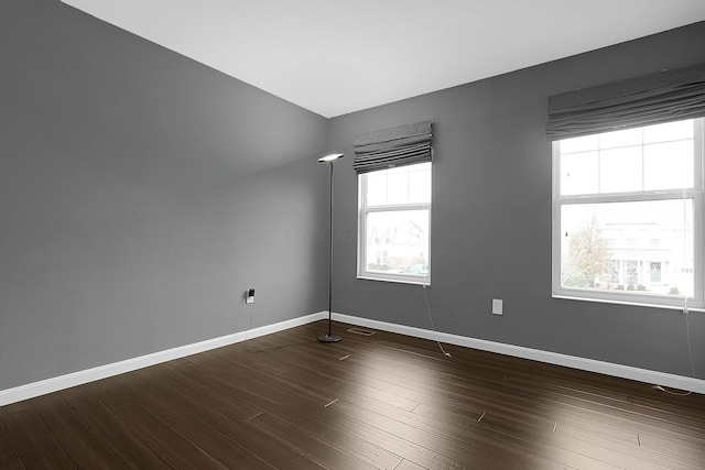 empty room featuring dark hardwood / wood-style floors and a wealth of natural light