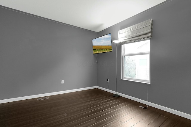 unfurnished room featuring dark wood-type flooring