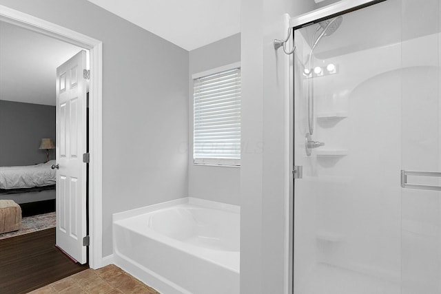 bathroom featuring hardwood / wood-style floors and shower with separate bathtub