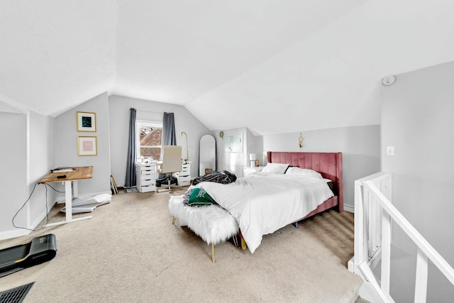 bedroom with carpet flooring and lofted ceiling