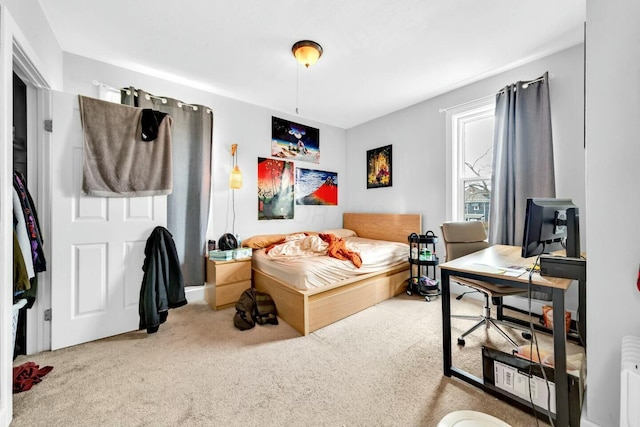 carpeted bedroom featuring radiator heating unit