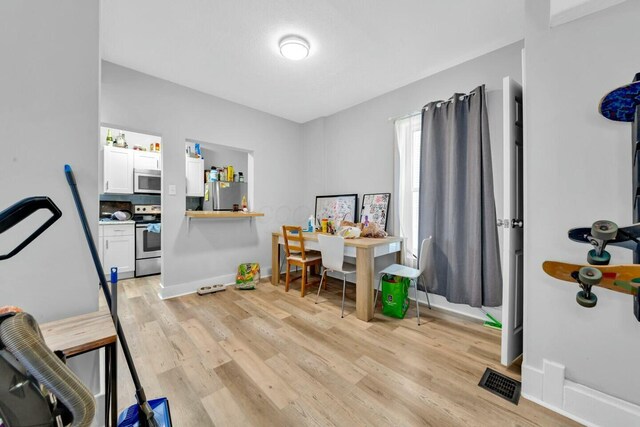 workout room featuring light hardwood / wood-style floors