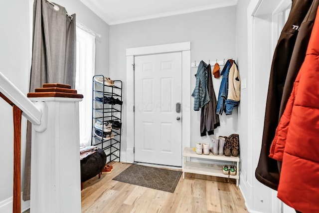 foyer entrance featuring light wood-type flooring and ornamental molding