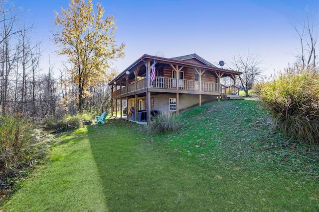 rear view of house with a yard and a wooden deck