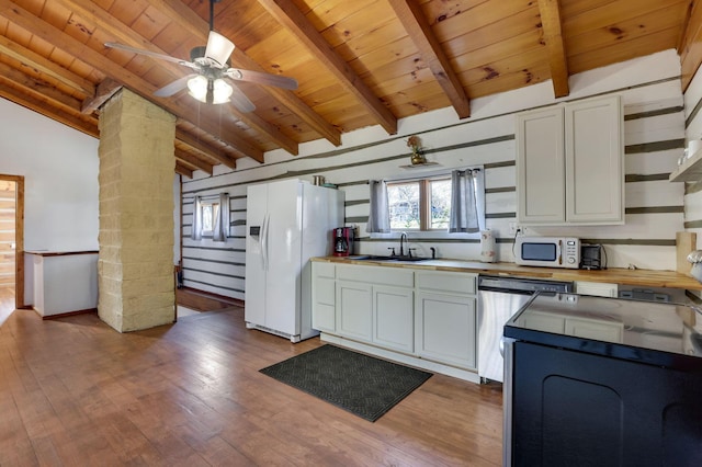 kitchen with sink, vaulted ceiling with beams, hardwood / wood-style floors, white appliances, and white cabinets