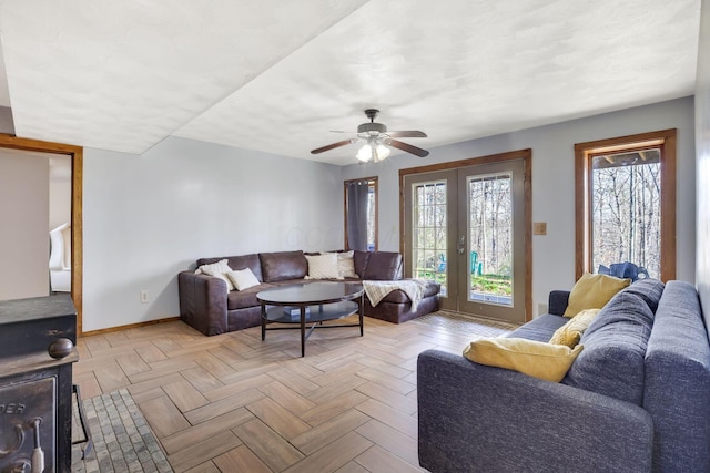 living room featuring ceiling fan, french doors, and light parquet floors