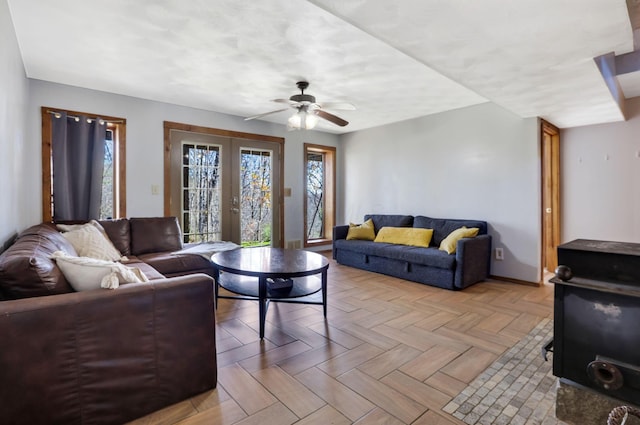 living room with ceiling fan, french doors, and light parquet flooring