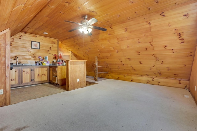 bonus room featuring lofted ceiling, sink, wooden walls, ceiling fan, and wood ceiling