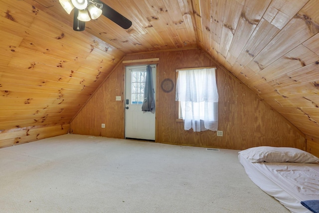 bonus room featuring carpet, wooden walls, vaulted ceiling, ceiling fan, and wood ceiling