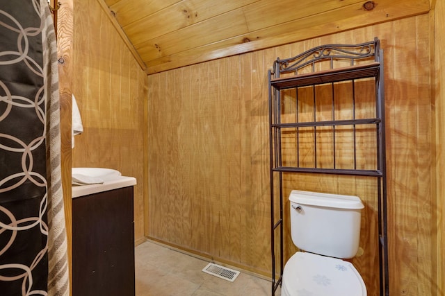 bathroom with vanity, wooden walls, tile patterned flooring, toilet, and wood ceiling