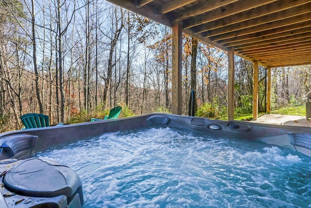 view of swimming pool featuring a hot tub