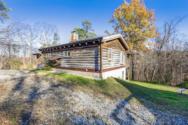 view of side of home with a lawn