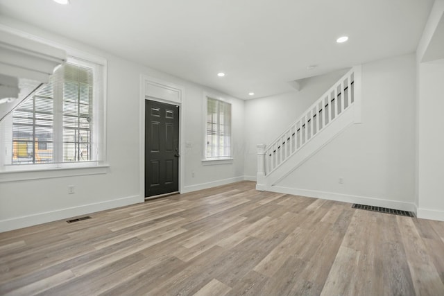 entryway with plenty of natural light and light hardwood / wood-style floors