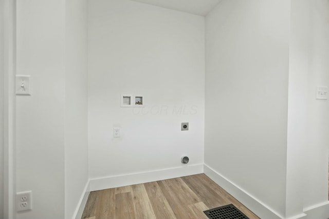 washroom featuring hardwood / wood-style flooring, hookup for an electric dryer, and hookup for a washing machine