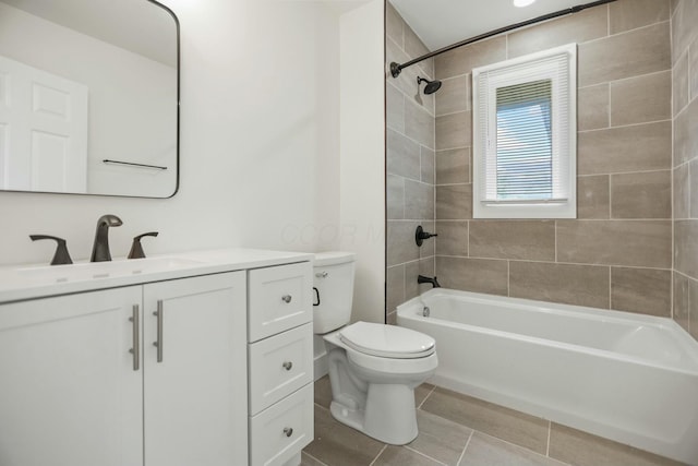 full bathroom with tile patterned floors, toilet, vanity, and tiled shower / bath