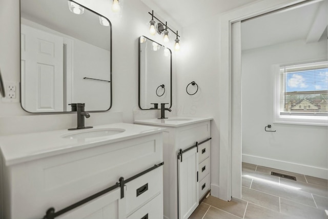 bathroom with tile patterned floors and vanity