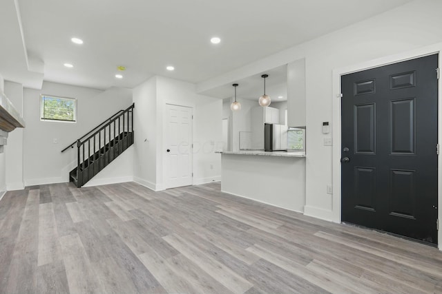 unfurnished living room with light hardwood / wood-style floors