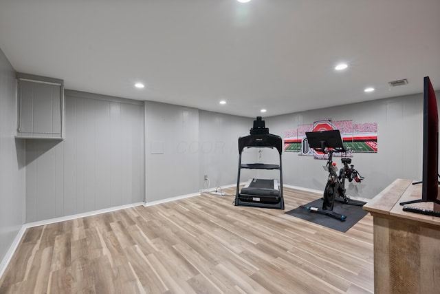 workout room with light hardwood / wood-style flooring