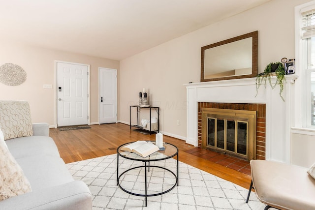 living room featuring wood-type flooring and a fireplace