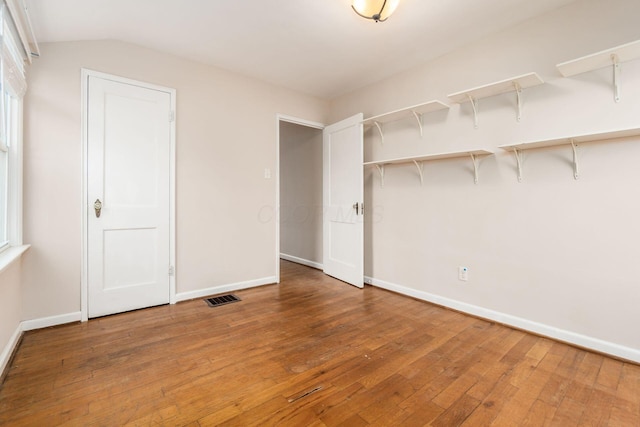 interior space featuring hardwood / wood-style floors and lofted ceiling