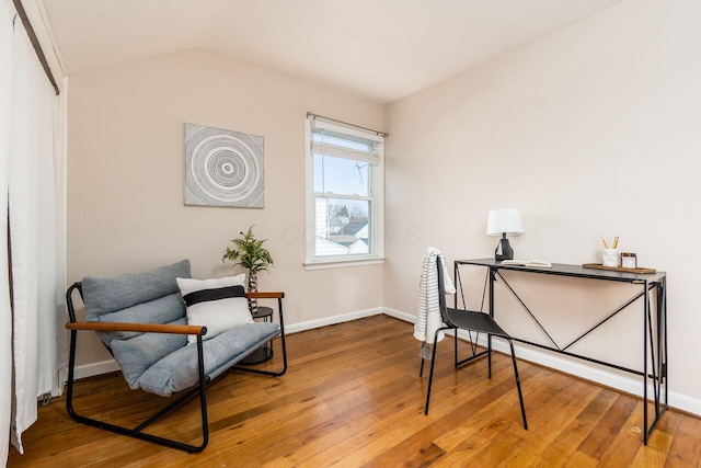 sitting room with hardwood / wood-style floors and lofted ceiling