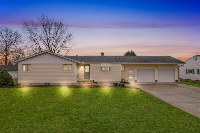 ranch-style home with a garage and a lawn